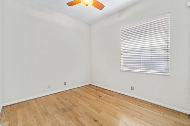 unfurnished room featuring ceiling fan, baseboards, and wood finished floors