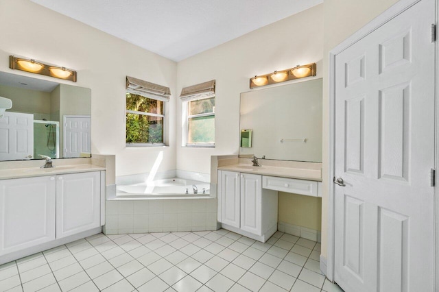 full bathroom with a garden tub, a shower stall, two vanities, and a sink