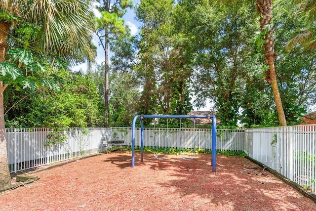 view of yard with playground community and fence