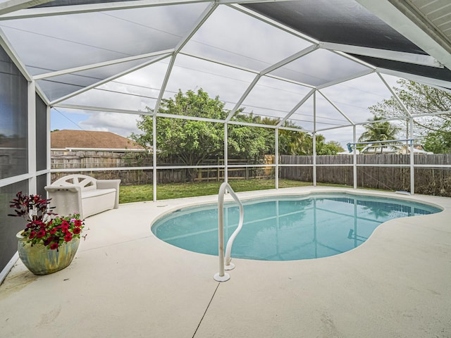 view of swimming pool with a fenced in pool, glass enclosure, a patio area, and a fenced backyard