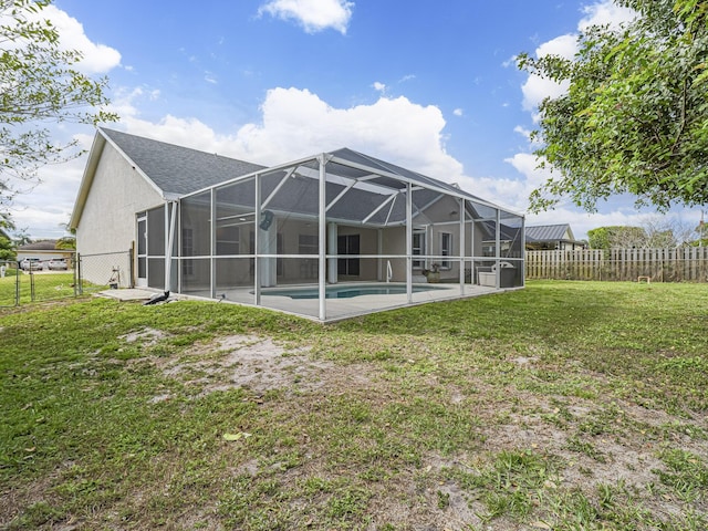back of house with a patio, a fenced backyard, a lanai, a yard, and a fenced in pool
