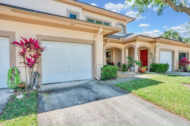 view of front facade featuring concrete driveway and stucco siding