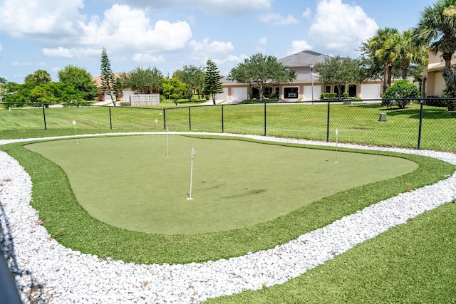 view of property's community with a yard and fence