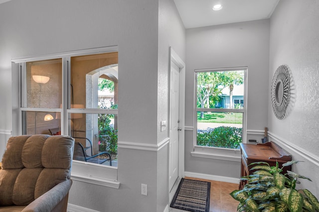 doorway to outside with recessed lighting and baseboards