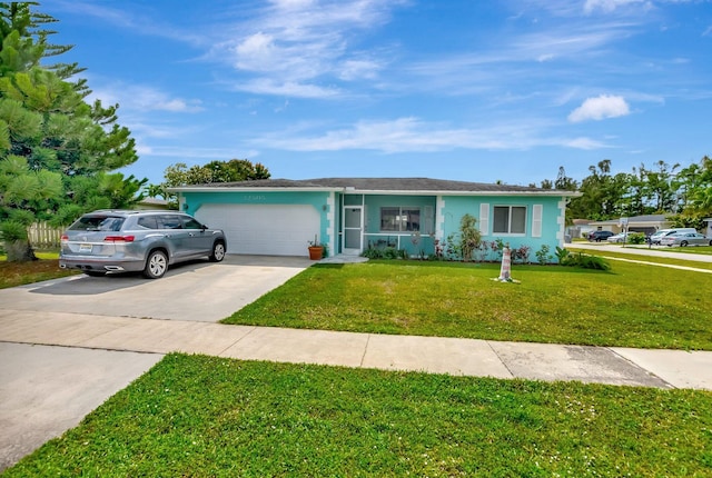 ranch-style home featuring concrete driveway, stucco siding, an attached garage, and a front yard