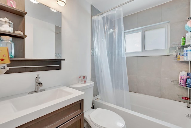 bathroom featuring toilet, shower / bathtub combination with curtain, and vanity