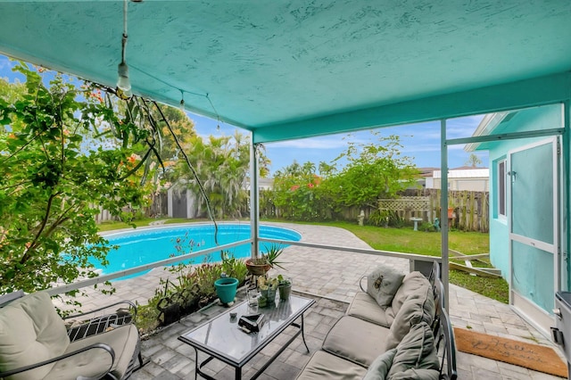 view of swimming pool featuring a patio, a fenced backyard, an outdoor hangout area, a yard, and a fenced in pool