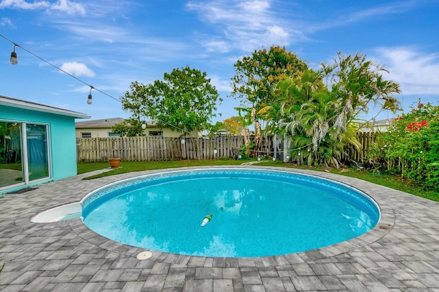 view of swimming pool featuring a fenced in pool, a patio area, and a fenced backyard