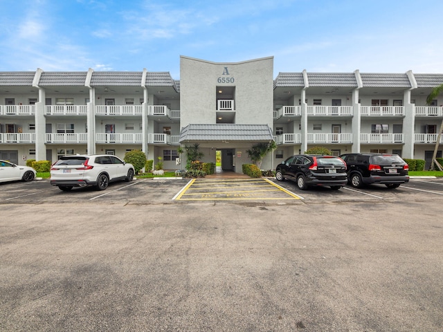 view of building exterior featuring uncovered parking