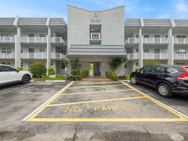 view of property with uncovered parking