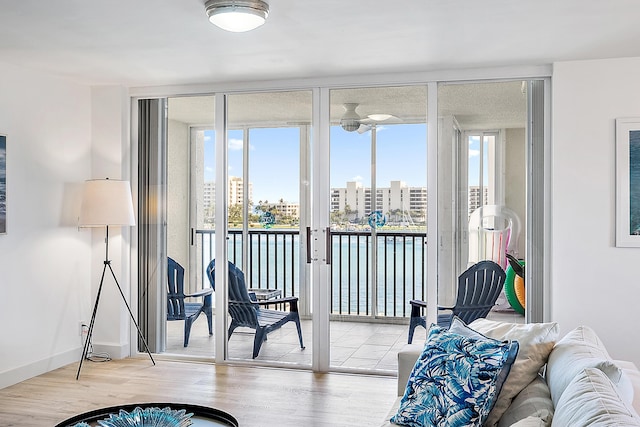 interior space featuring a view of city, wood finished floors, and a healthy amount of sunlight