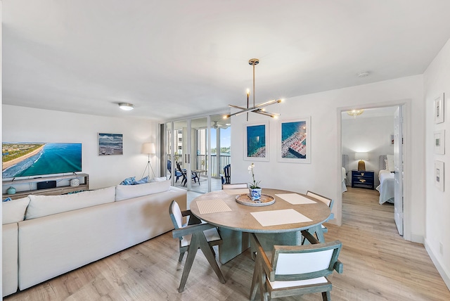 dining area with an inviting chandelier and light wood-style floors