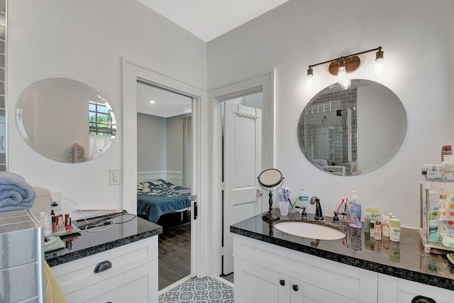 full bath with vanity, ensuite bath, and wood finished floors