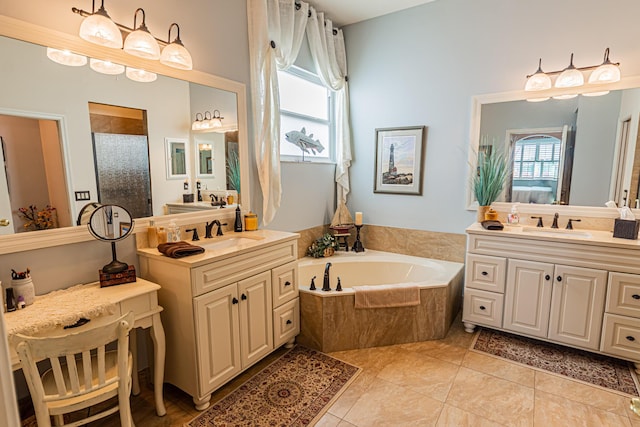 bathroom with a garden tub, two vanities, a sink, a shower stall, and tile patterned floors