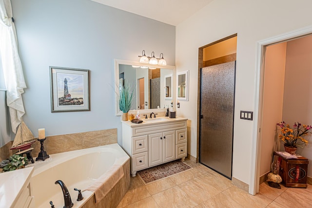 full bathroom with a garden tub, a shower stall, vanity, and tile patterned floors