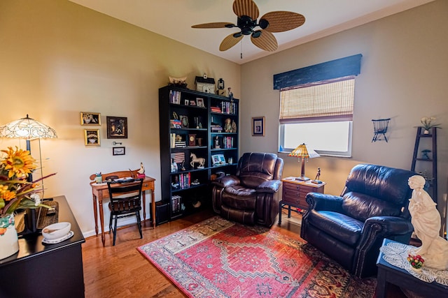 sitting room with a ceiling fan and wood finished floors