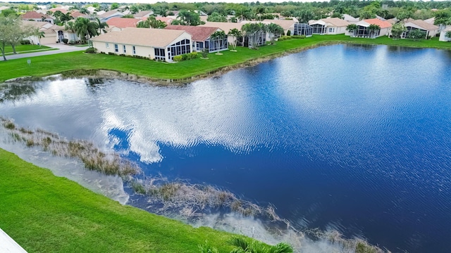 drone / aerial view featuring a water view and a residential view