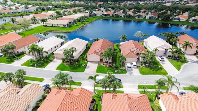 birds eye view of property with a water view and a residential view