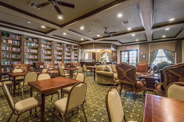 interior space featuring visible vents, ornamental molding, coffered ceiling, and a ceiling fan