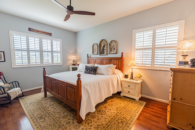 bedroom with dark wood-type flooring, baseboards, and a ceiling fan