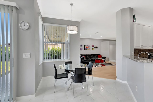 dining area with light tile patterned floors, baseboards, crown molding, and recessed lighting