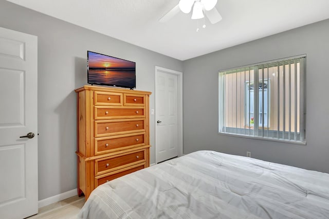 bedroom featuring ceiling fan and baseboards