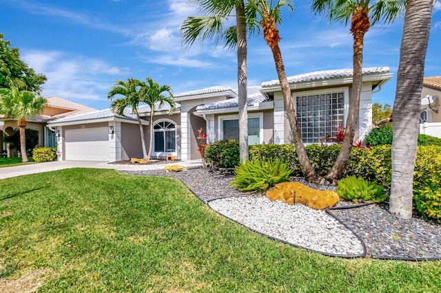 ranch-style home with a tiled roof, an attached garage, driveway, and a front yard