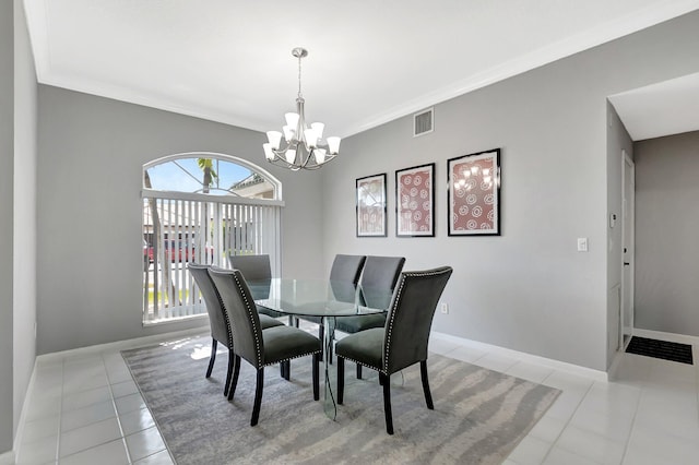 dining space featuring baseboards, a chandelier, crown molding, and light tile patterned flooring