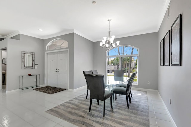 dining area with a notable chandelier, crown molding, visible vents, and baseboards