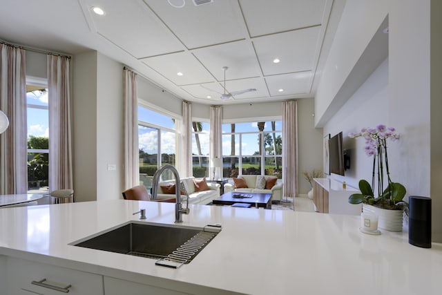 kitchen with plenty of natural light, open floor plan, light countertops, and a sink