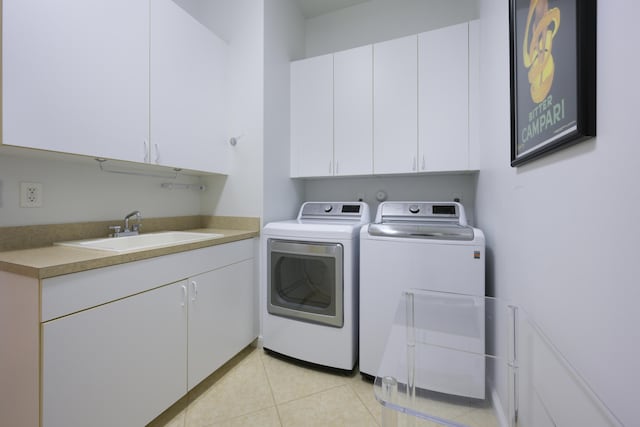 laundry room with cabinet space, light tile patterned floors, a sink, and independent washer and dryer