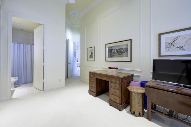 office area featuring light carpet, baseboards, visible vents, crown molding, and a decorative wall