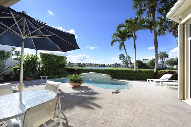 pool with outdoor dining space and a patio area