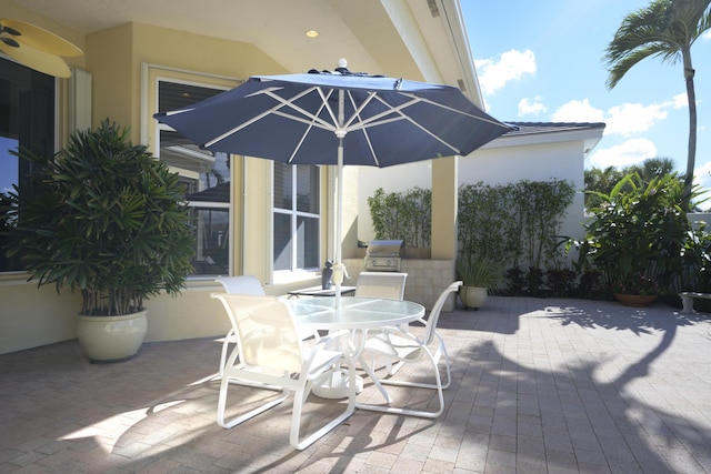 view of patio with outdoor dining space and a grill