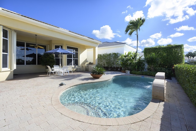 view of swimming pool with a patio area, a fenced in pool, and a ceiling fan