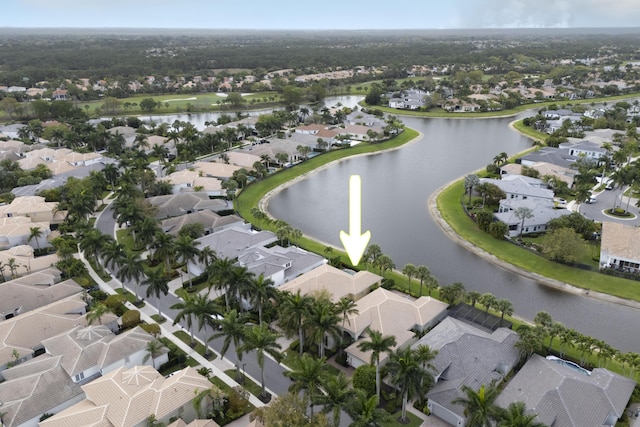 drone / aerial view featuring a residential view and a water view