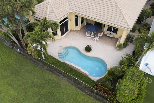 view of pool with a yard, a patio, a fenced backyard, and a fenced in pool