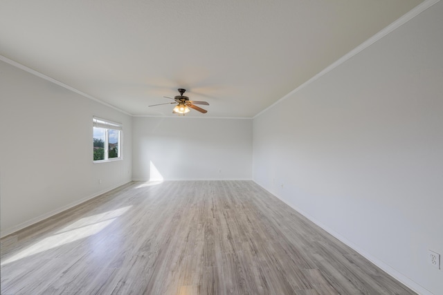 unfurnished room featuring ornamental molding, light wood-type flooring, baseboards, and a ceiling fan