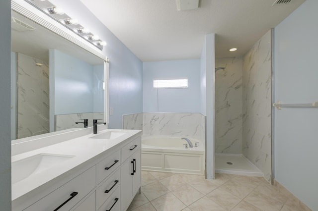 bathroom featuring a garden tub, a marble finish shower, visible vents, and a sink