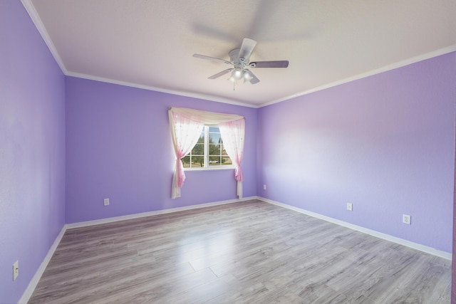 unfurnished room with ceiling fan, crown molding, baseboards, and wood finished floors