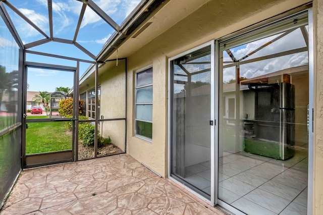 unfurnished sunroom featuring lofted ceiling