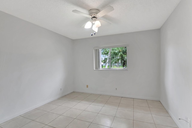 empty room featuring a textured ceiling, baseboards, and a ceiling fan