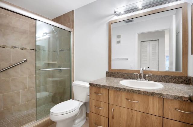 bathroom featuring toilet, a shower stall, visible vents, and vanity