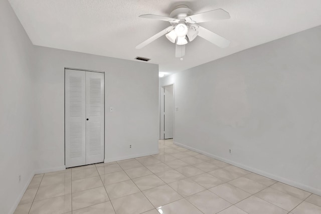 unfurnished bedroom with ceiling fan, a closet, visible vents, and baseboards