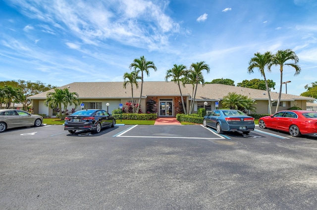 view of property featuring uncovered parking