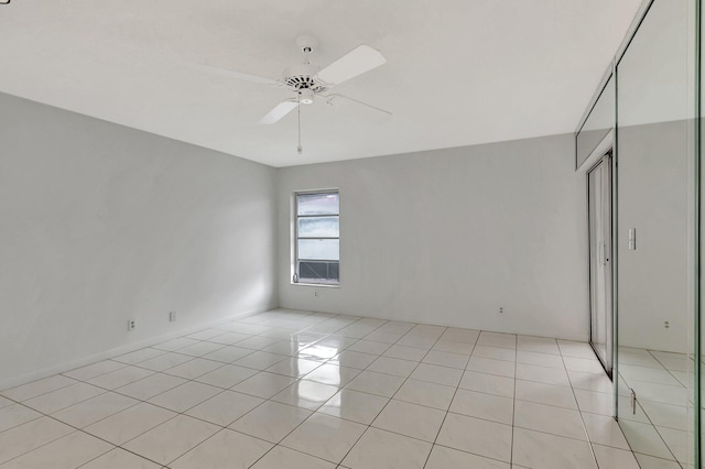 unfurnished room with ceiling fan and light tile patterned flooring