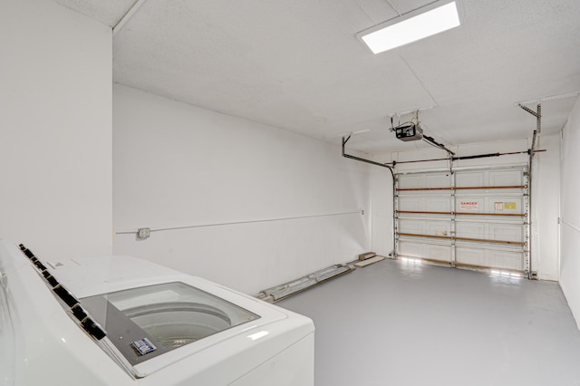 garage featuring washer / clothes dryer and a garage door opener