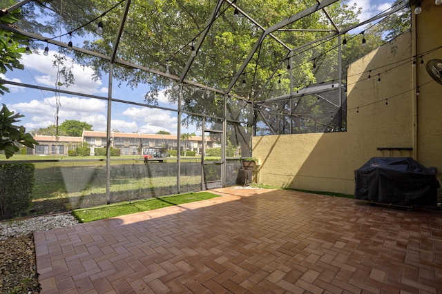 view of patio / terrace with glass enclosure and area for grilling