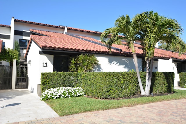 view of front of house with a tiled roof and stucco siding