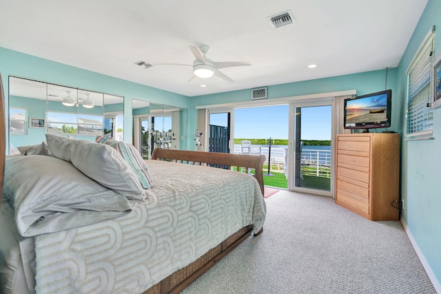 bedroom with access to outside, visible vents, light carpet, and baseboards